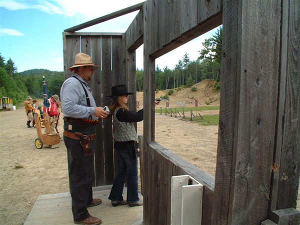 Shooting pistol while being timed by Jake Mountain.