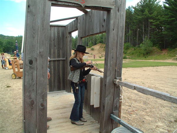 Reloading her double-barreled shotgun.