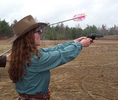 Shooting with an arrown through her hat.