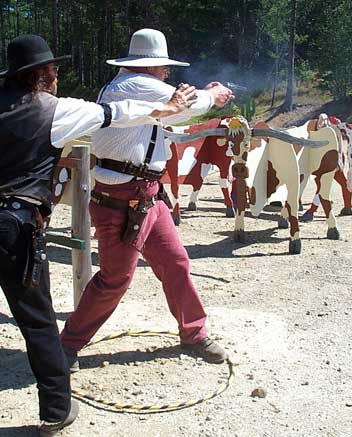 Jake Mountain shooting pistol while timed by Preacher Rick.