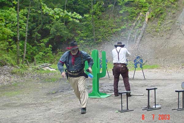 Smokey Sue finishing his pistol stage at the July 2003 Falmouth Shoot with LaBouche hauling ass to get out of the way.