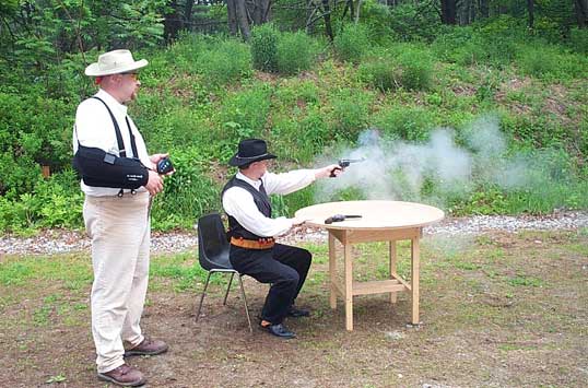 Dead Head shooting pistol with his off hand while being timed by Broken Wing Mountain.