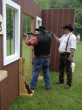 Baja Pa shooting rifle at the June 2003 Shoot while being timed by Smokey Sue.