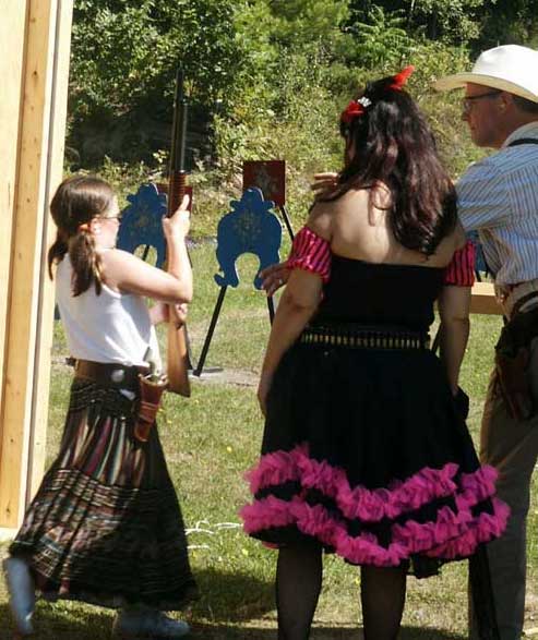 Little Britches carrying her shotgun to the firing line.