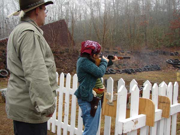 Snazzy McGee shooting rifle while being timed by Chantry.