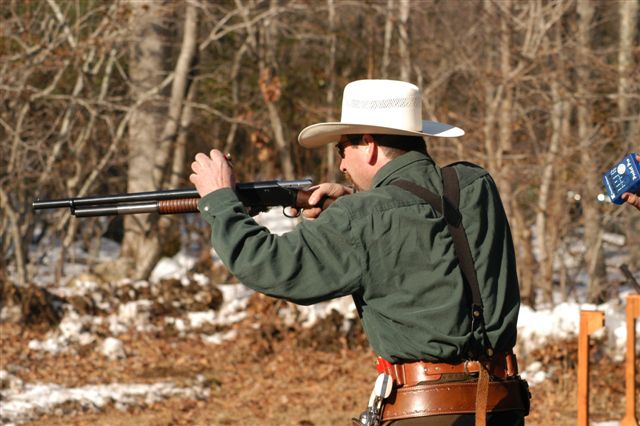 Loading his 1897 shotgun over the top ...