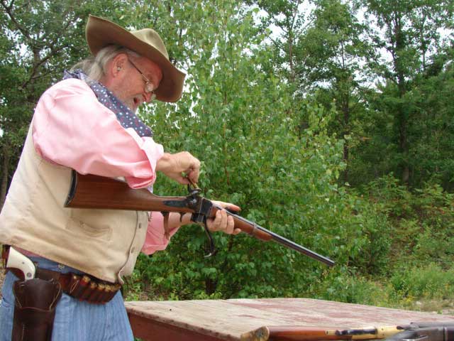 Chuckwagon Bob loading his single shot rifle.