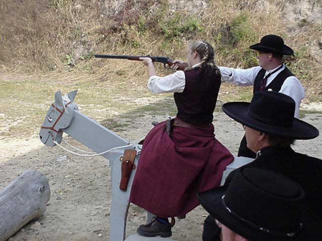 Dakota Miss shooting rifle off of her horse in Kinnicum Creek in June 2002.