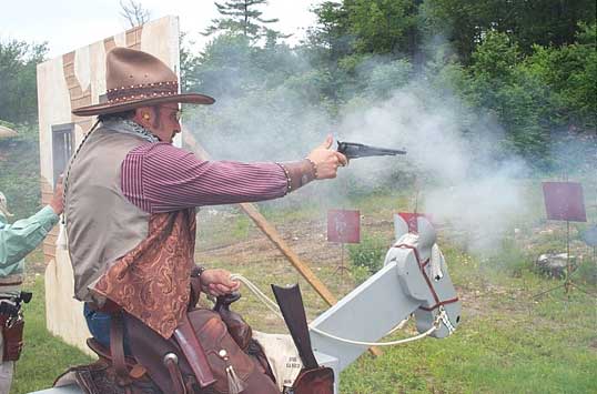 The Lazarus Man shooting pistol on the horse.