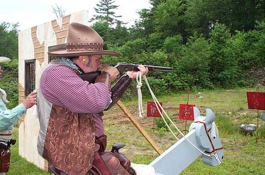 The Lazarus Man shooting rifle on the horse.