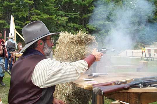 Blazing with his pistols.