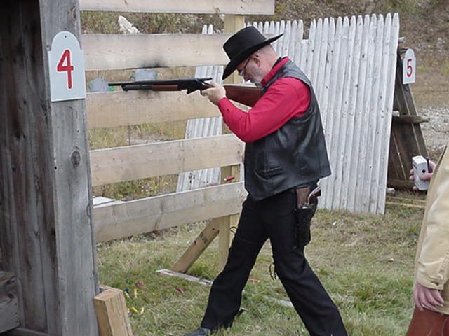 Sled Dog Man looking for shells to reload shotgun.