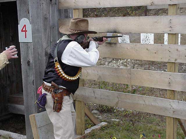 Wooly Woody with shotgun through the fence.